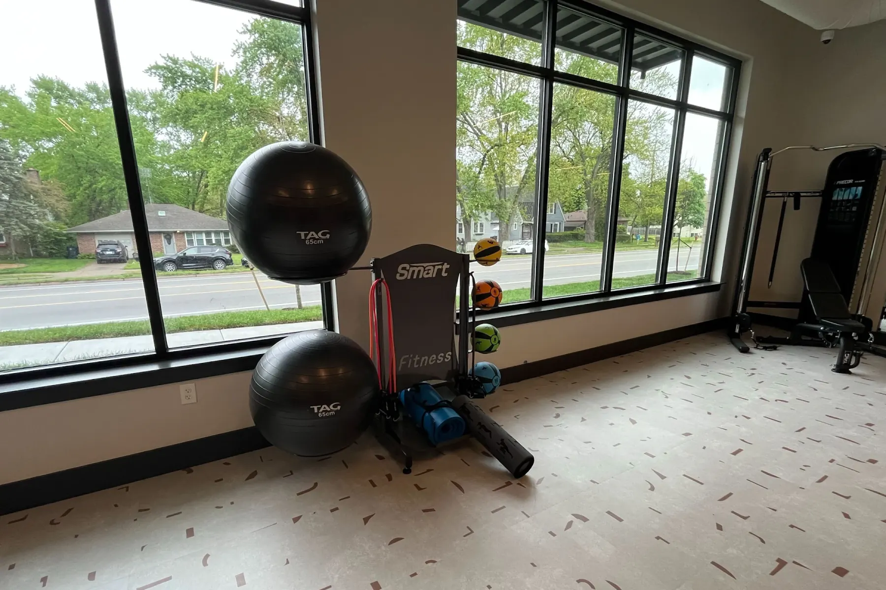Stability ball and medicine ball corner at Packard Row's fitness center with large windows facing the street